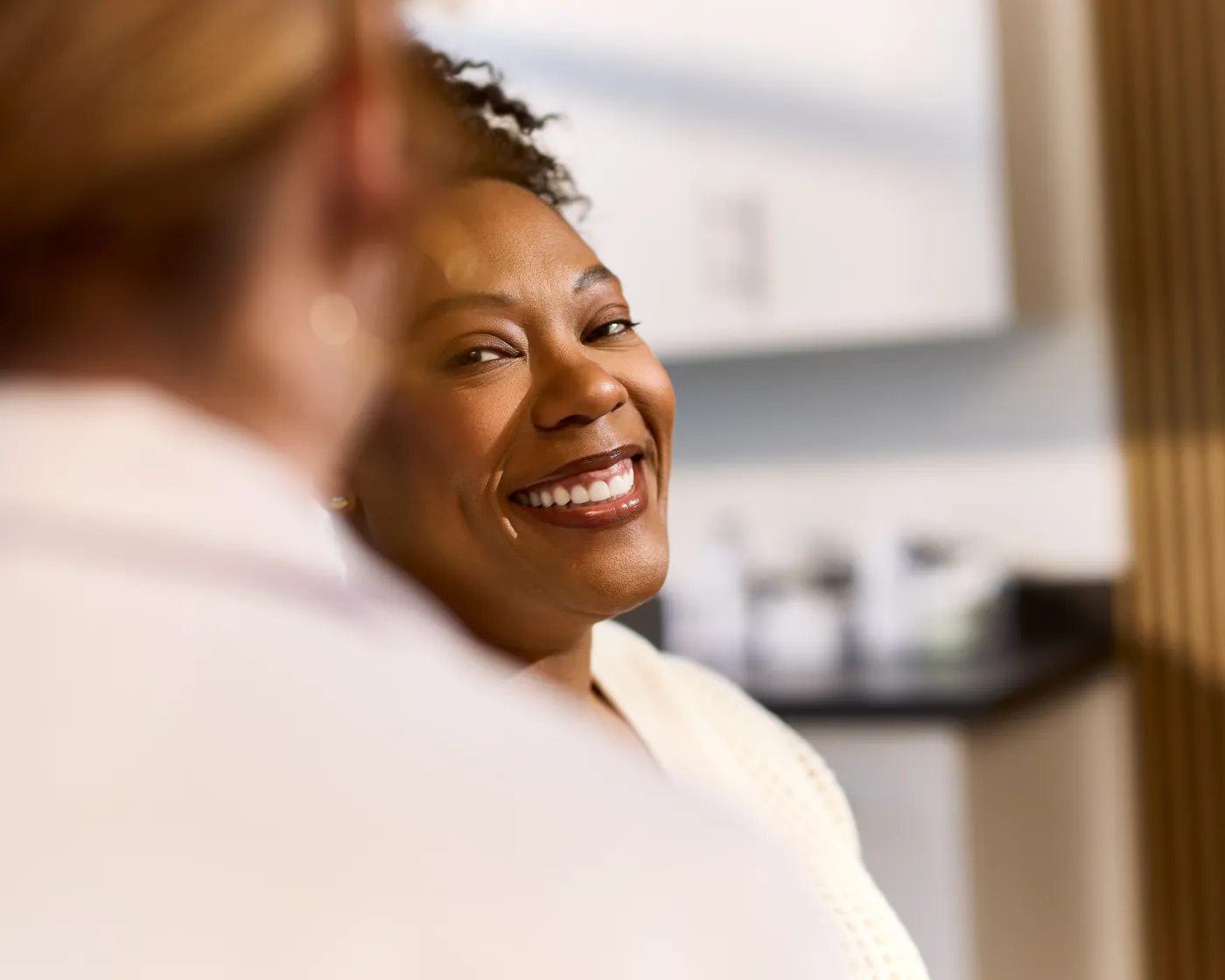Smiling patient in a QualDerm Partners exam room