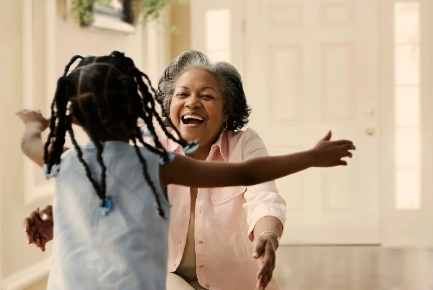Miracle-Ear homepage image of a grandmother greeting her granddaughter