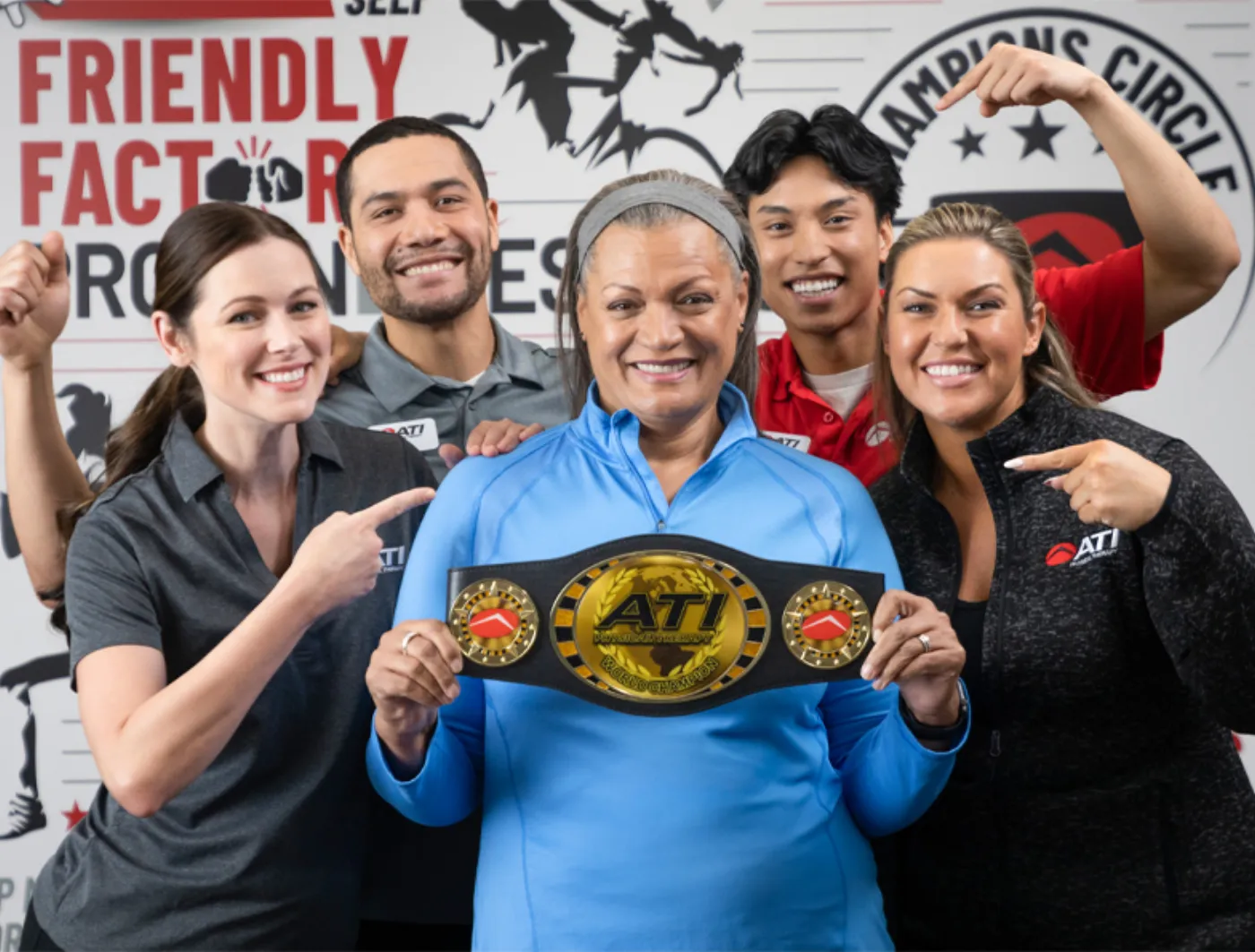 ATI Physical Therapy team posing together with a championship belt