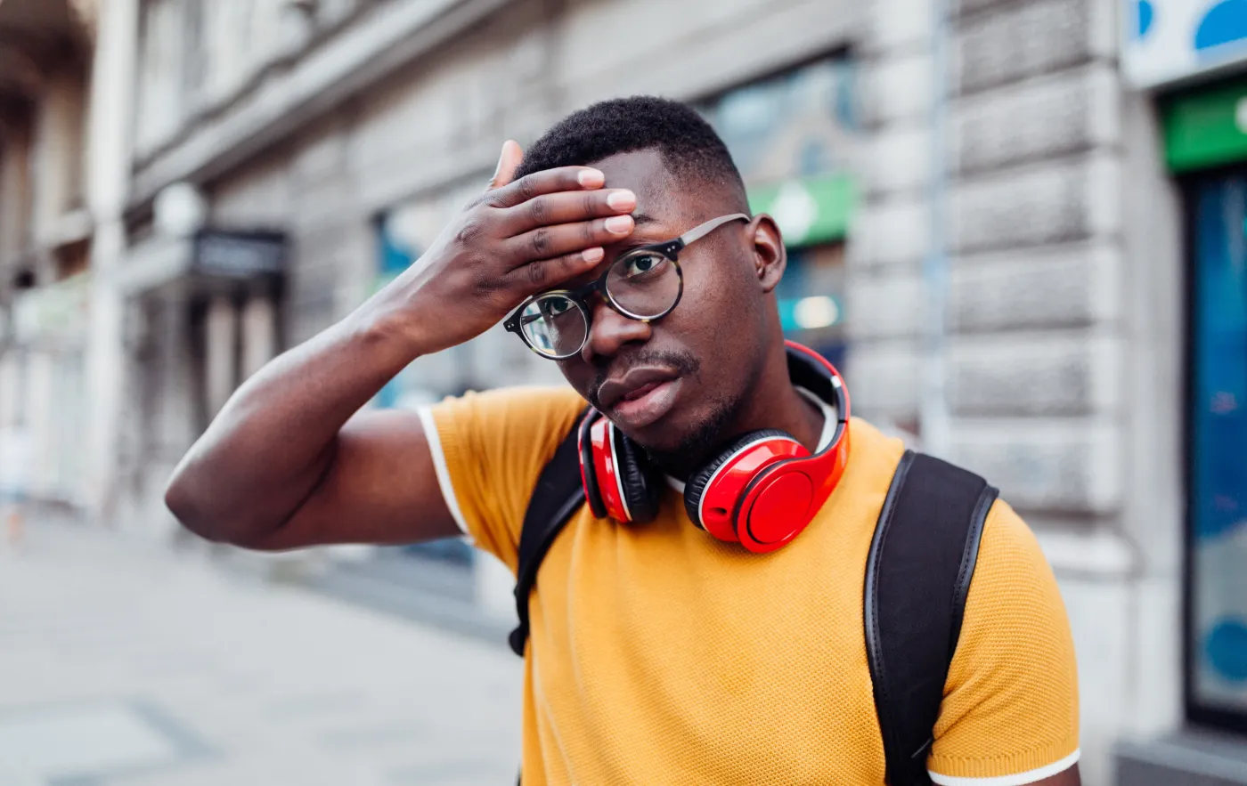 CityMD homepage image of a person feeling unwell while walking outside